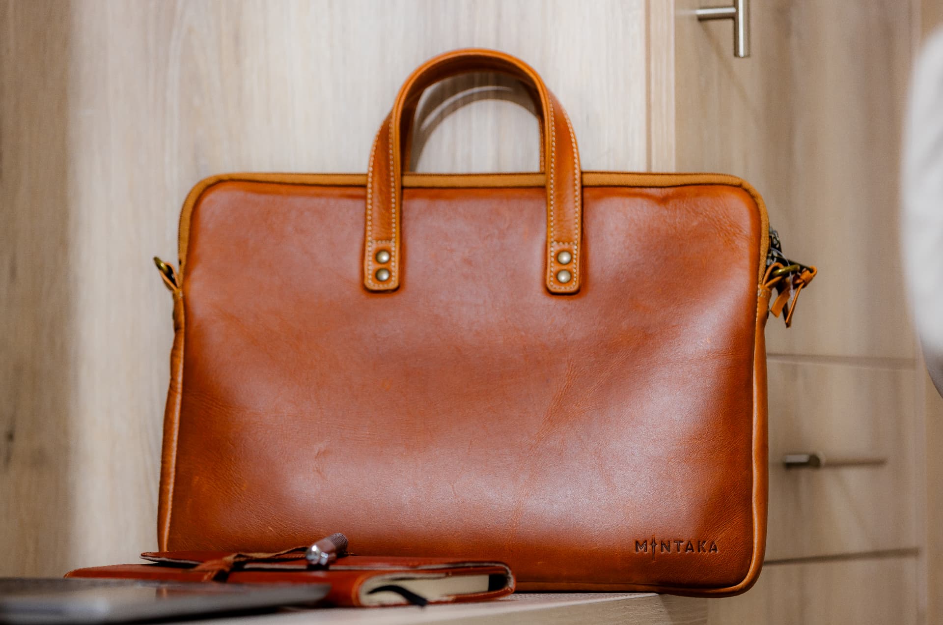 Vermont full-grain leather laptop bag on a desk